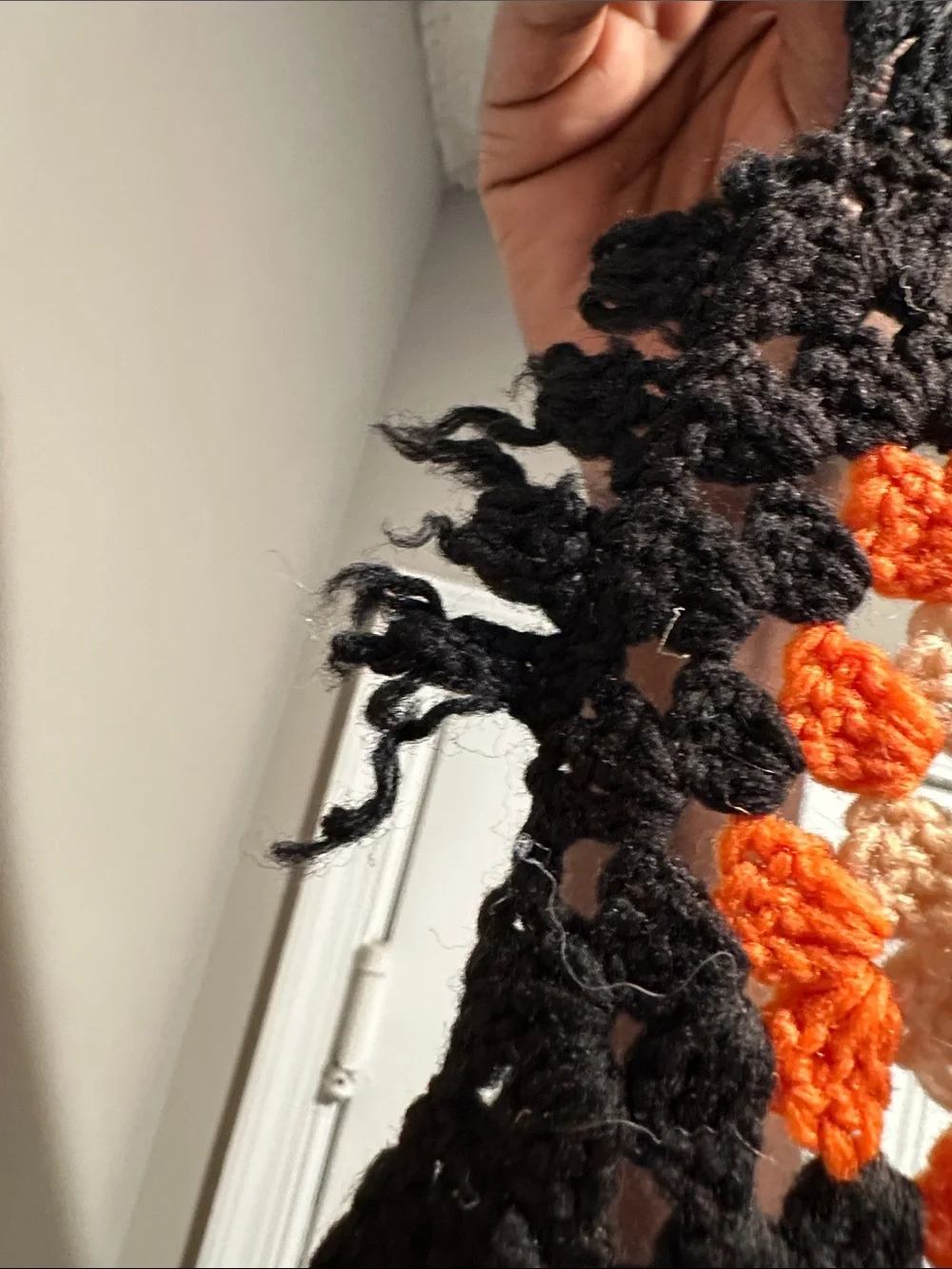 Granny Square black with orange crochet blanket with zig zag hem